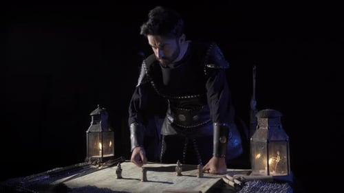 Man in Medieval Attire Studies Battle Map