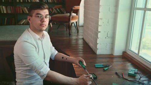 Young Adult Soldering Electronic Components Indoors