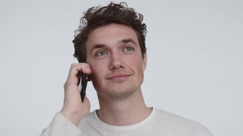 Male Model with a Serious Face Answering His Phone