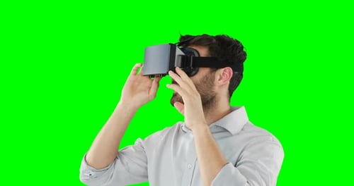 Man Immersed in Virtual Reality on Green Screen