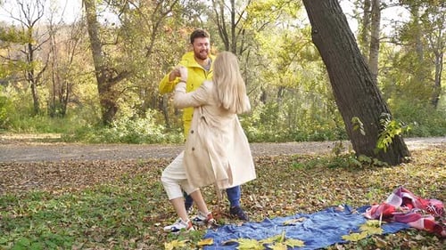 Romantic Picnic of a Beautiful Young Couple in Autumn Outdoors on a Sunny Day