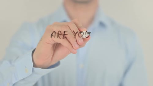 Man Writes Leadership Question on Clear Surface