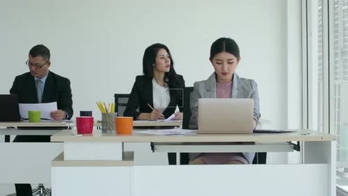Workers at Desks in Modern Office Space