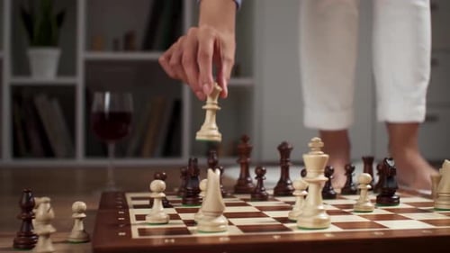 The Girl Makes A Move With A Chess Piece Queen. Strategy Chess Battle Party. A Woman's