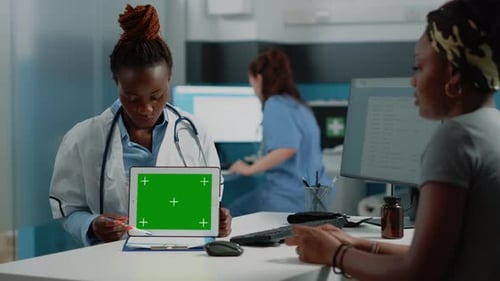 Woman Doctor Pointing at Tablet with Horizontal Green Screen