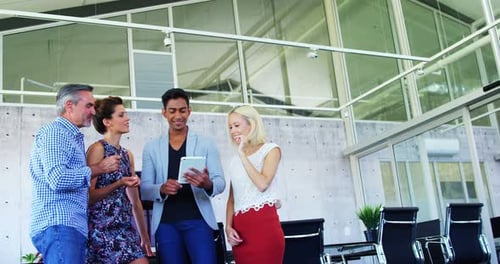 Colleagues Collaborating with Tablet in Modern Workplace