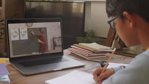 Child Studying Online with Laptop at Home