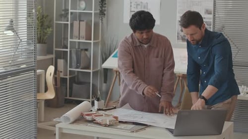 Team of Architects Discussing House Plan in Office