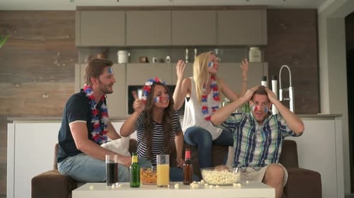 Friends Watch Game Together at Home on Couch