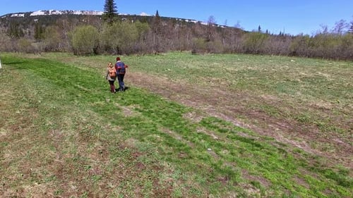 Couple Walking on Green Grass on Hike