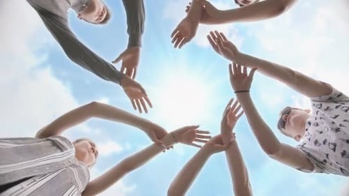 Friends Join Their Hands in a Circle