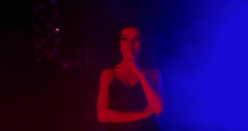 Woman Gestures for Silence in Dramatic Lighting