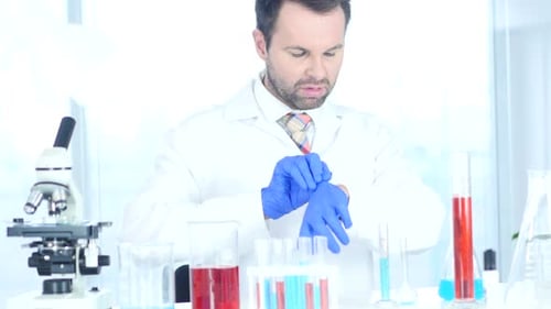 Scientist Putting on Surgical Gloves in Bright Lab