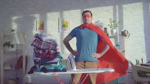 Superhero Doing Laundry in Living Room at Home