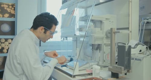 Scientist working in a pharmaceutical laboratory weighing chemicals