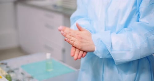 Adult Using Hand Sanitizer in Sterile Medical Setting