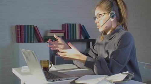 Footage of a Woman Works in Front of a Laptop Monitor in Office She Having Online Video Call