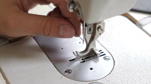 Threading a Sewing Machine Needle Close Up