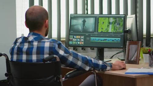 Man in Wheelchair Working at Computer