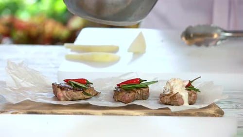 Chef Preparing Gourmet Beef Appetizers with Fresh Ingredients