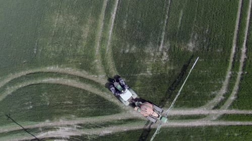 Tractor Sprays Fertilizer in Verdant Green Field