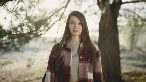Smiling Woman Poses Outdoors in Natural Light