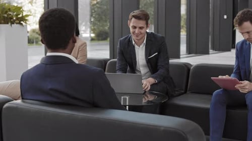 Business People Meeting in Modern Office Lobby