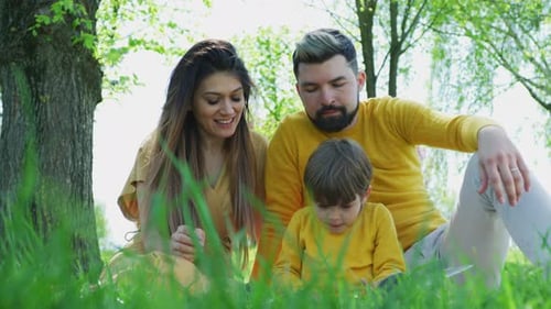 Family Relaxing Together in a Grassy Park