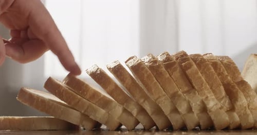 Sliced Bread On The Table With Fingers Counting Slices Shot On Red Camera