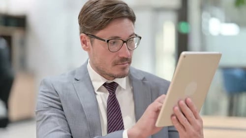 Man Uses Tablet in Modern Office Environment