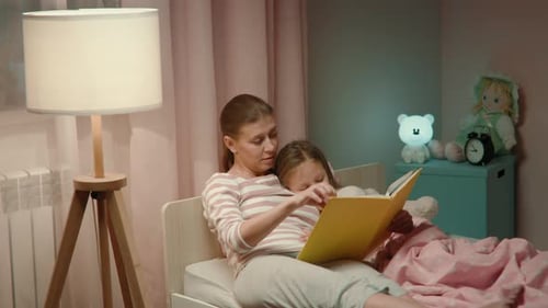 Mom Reads to Child at Bedtime, Indoors