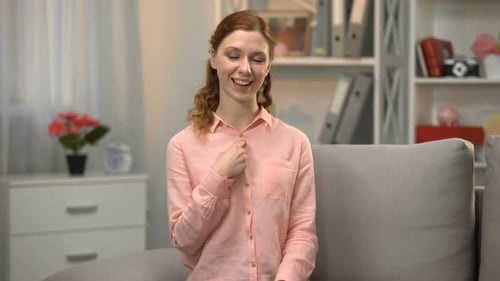 Young Woman Communicating Using Sign Language Indoors