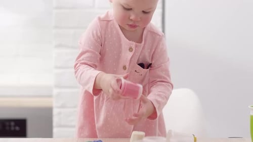 Toddler Playing with Clay in Bright Kitchen