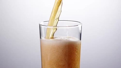 Beverage Poured into Glass with Ice and Foam