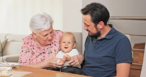 Three Generations Bonding: Infant, Father and Grandmother
