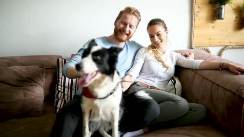 Couple Relaxing at Home with Their Dog