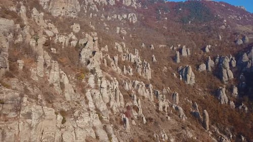 Aerial View of Flight Over Mountainous Terrain with High Cliffs