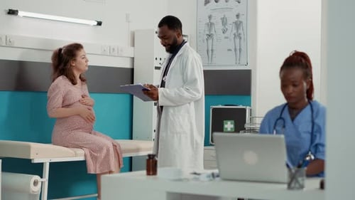 Pregnant Woman with Doctor in Exam Room