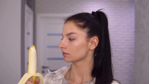 Woman Eats a Banana Close Up