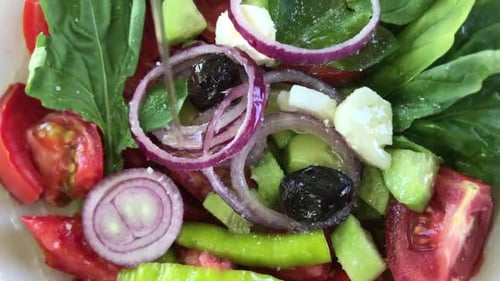 Olive Oil Poured Over Fresh Vegetable Salad