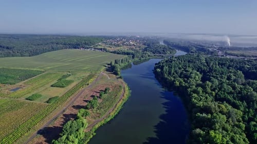 Aerial View of Winding River Through Countryside