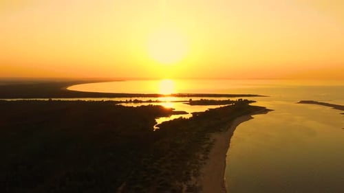 4K UHD Aerial drone view Beautiful sunset over tropical beach with clouds In the middle of the sea
