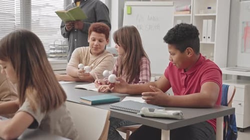 School Children Examining Molecular Models in Class