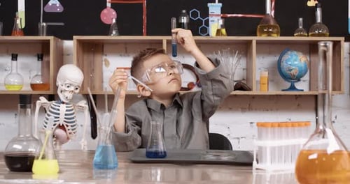 Boy Doing Science Experiment with Glassware