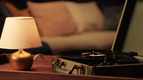 Vintage Record Player and Lamp in Dimly Lit Room