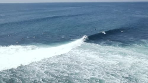 Aerial Shot Barreling Waves with Surfers Doing Surf Stunts and Paddling in Sea