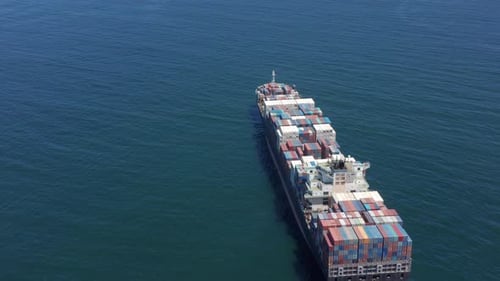 Aerial Top View of Cargo Ship Carrying Container and Running with Tug Boat for Export Goods From