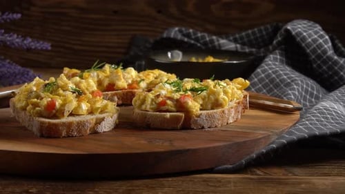 Scrambled eggs on a slice of bread.