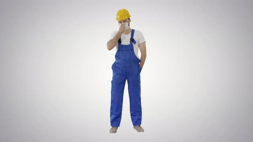Construction Worker Wearing PPE Stands with Hands Pockets