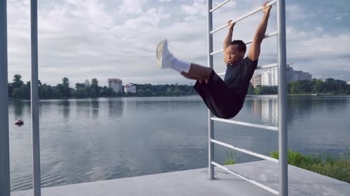 Man Doing Leg Lifts at Lakeside Workout